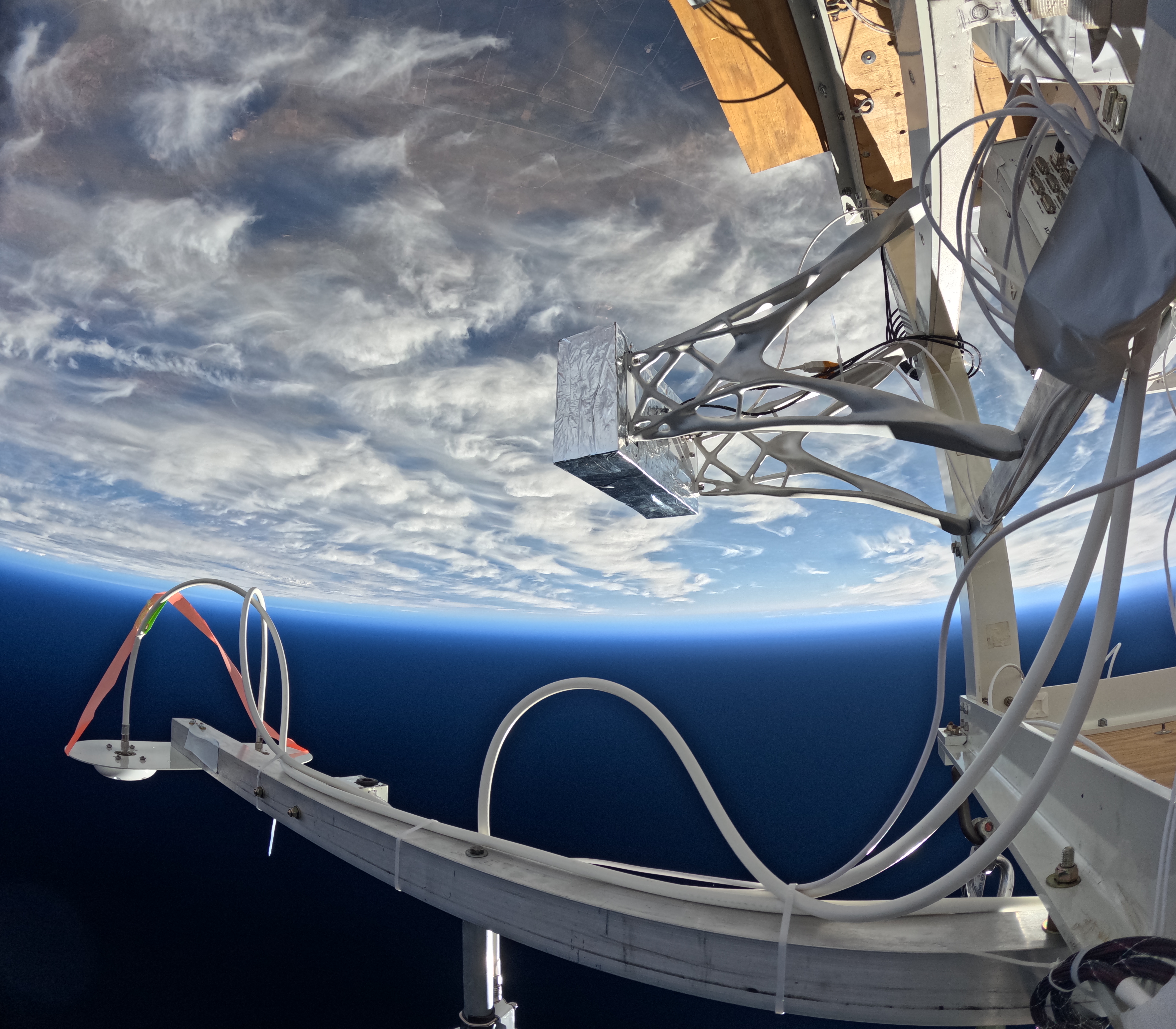 T2S-1 flight enclosure on the BOOP scientific balloon gondola — algorithmically optimized structures machined from aluminum billet, built by Pathfinder Labs.